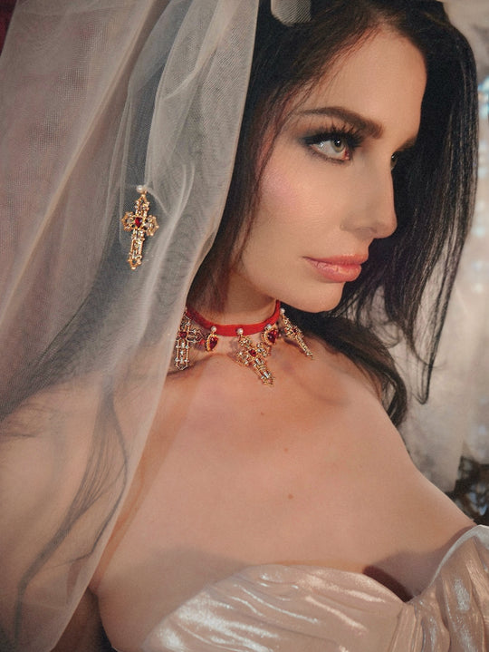 Close-up portrait of brunette bride wearing the Cross My Heart Jeweled Charm Wedding Veil and Cross My Heart Jeweled Charm Bridal Choker