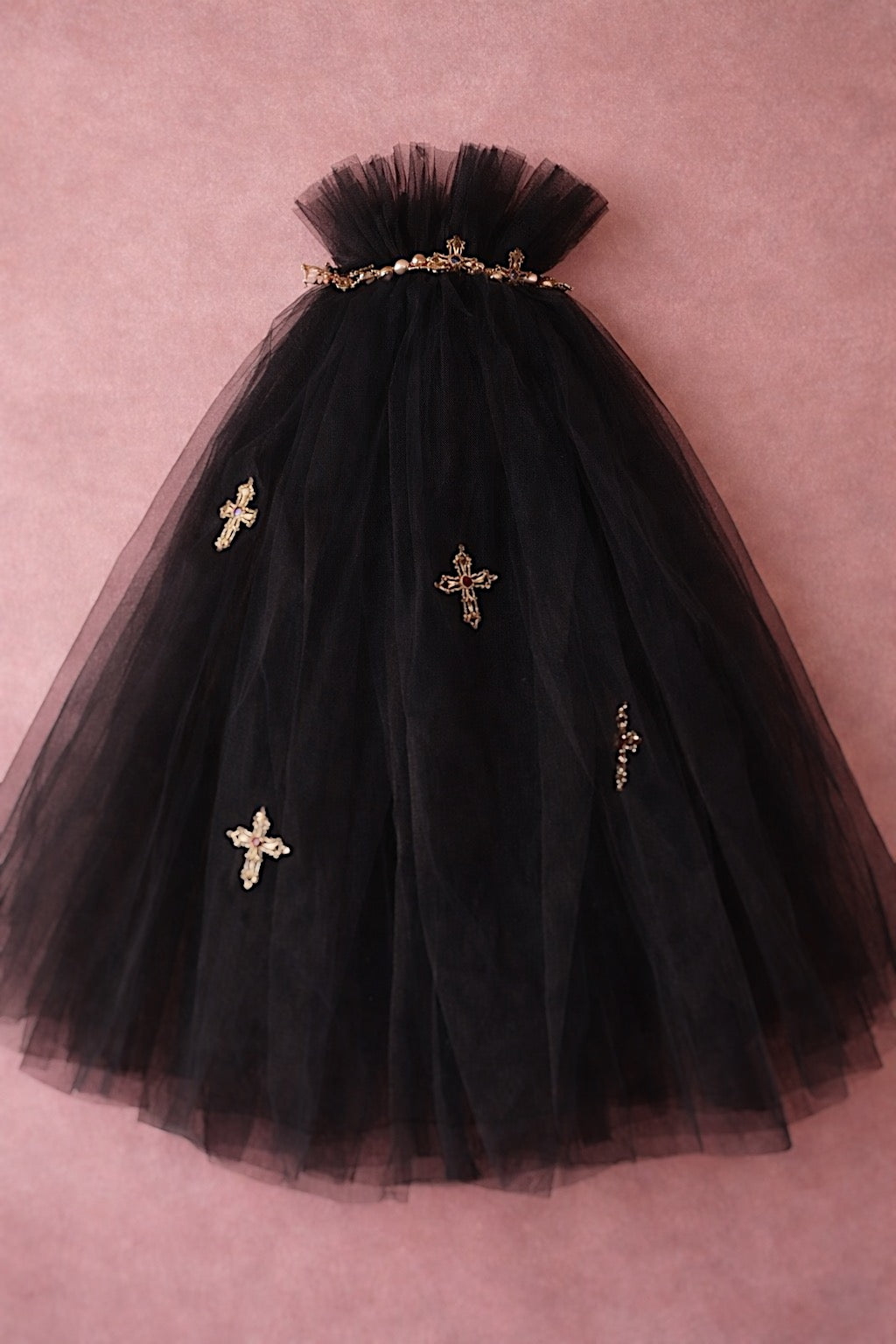 Black Cross My Heart Jeweled Charm Wedding Veil with gold cross charms against a blush backdrop