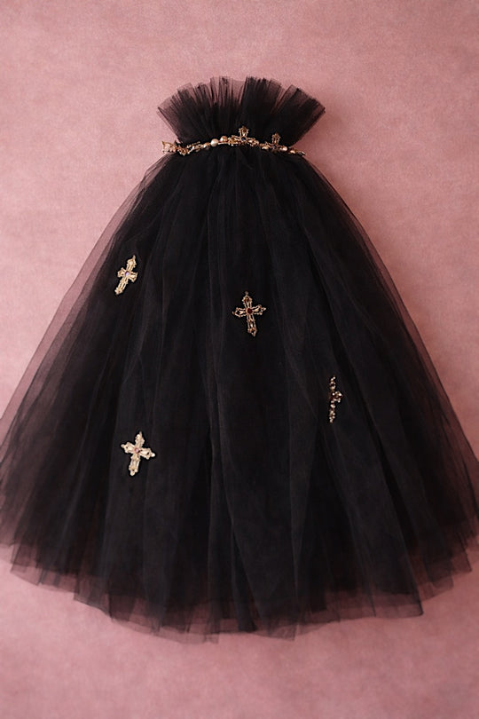 Black Cross My Heart Jeweled Charm Wedding Veil with gold cross charms against a blush backdrop