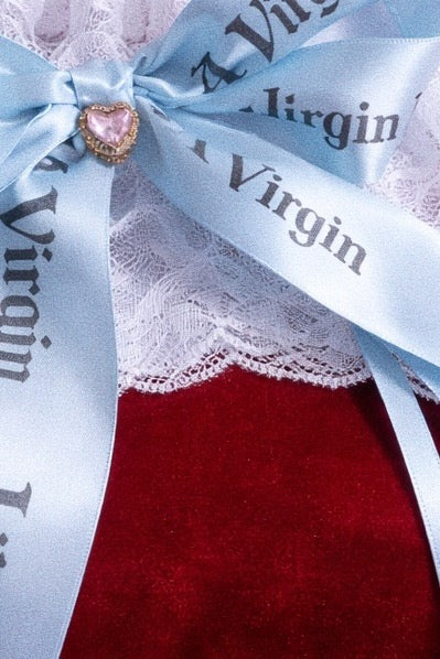 Close-up of baby blue Like A Virgin satin bow wedding garter with Austrian crystal heart and stretch lace