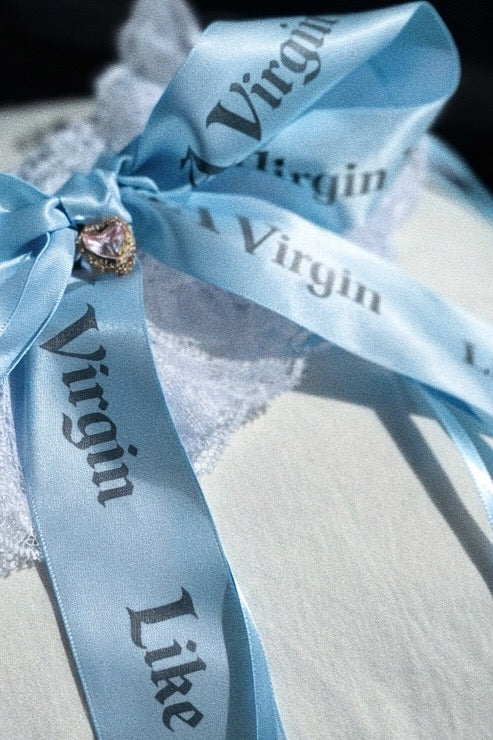 Statement bridal garter in baby blue satin with oversized printed ribbons and lace base