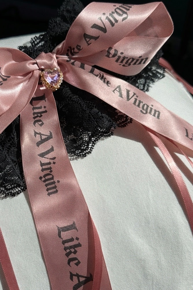 Like A Virgin blush satin bow bridal garter on black lace with crystal heart charm