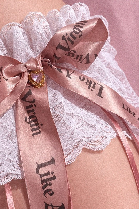 Like A Virgin blush satin bow bridal garter with lace band and crystal heart charm