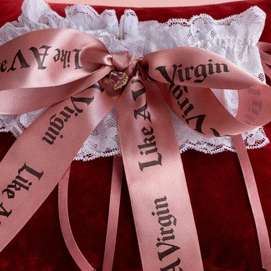 Statement lace wedding garter featuring multiple blush satin bows and crystal heart charms