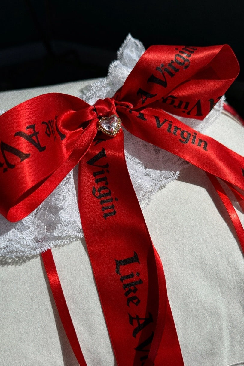 Red satin Like A Virgin wedding garter with oversized printed ribbon and lace stretch band