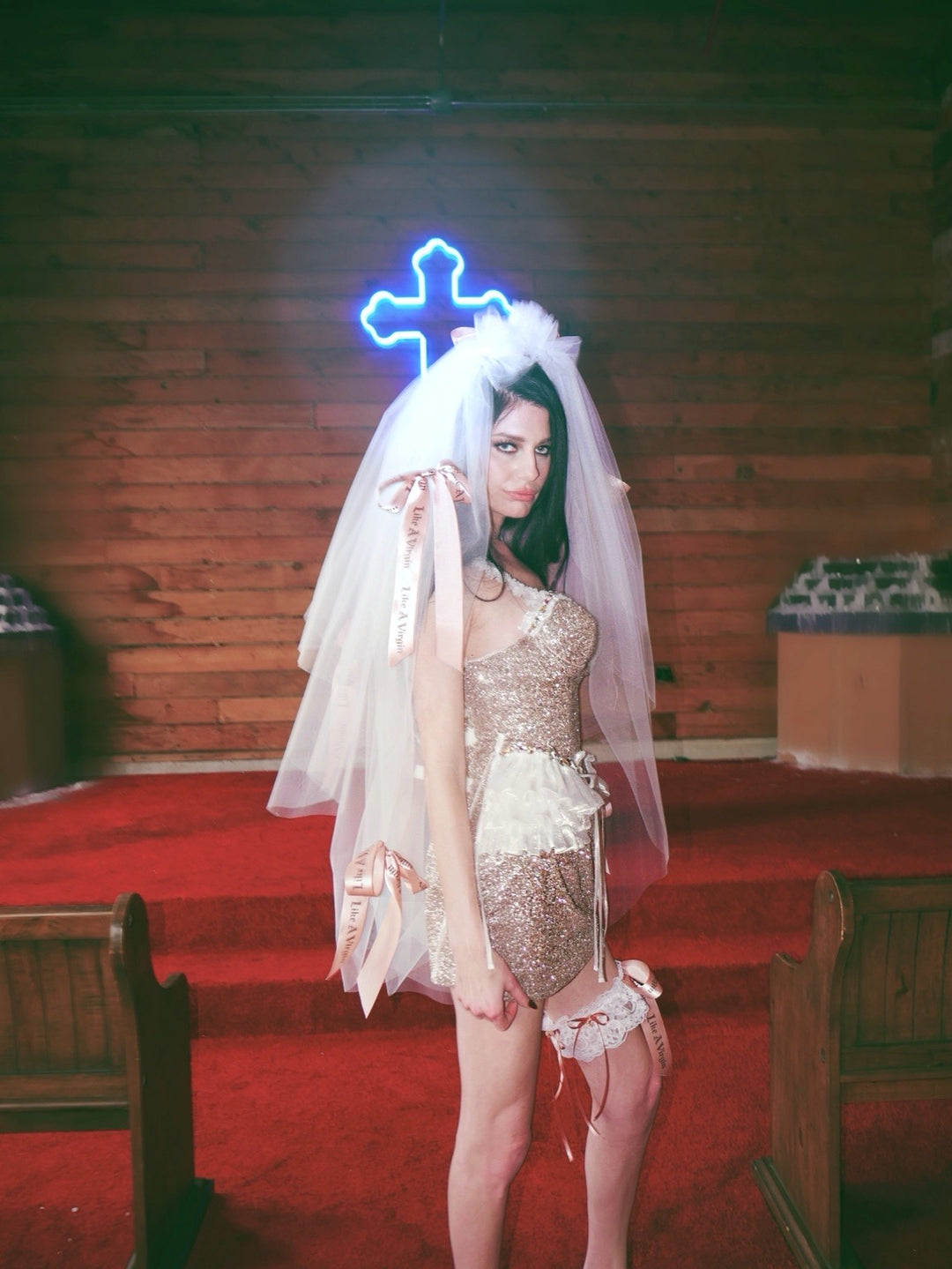 Close view of Like A Virgin satin bow wedding veil with printed ribbon bows and alternative bridal garter