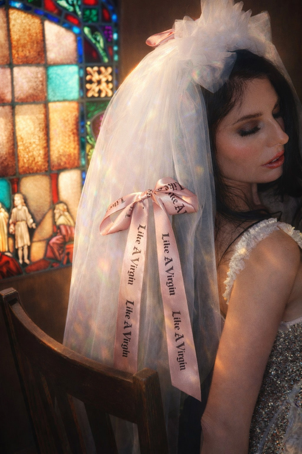 Close up of Like A Virgin satin bow wedding veil with printed ribbon detail and blush satin bow for modern bridal styling