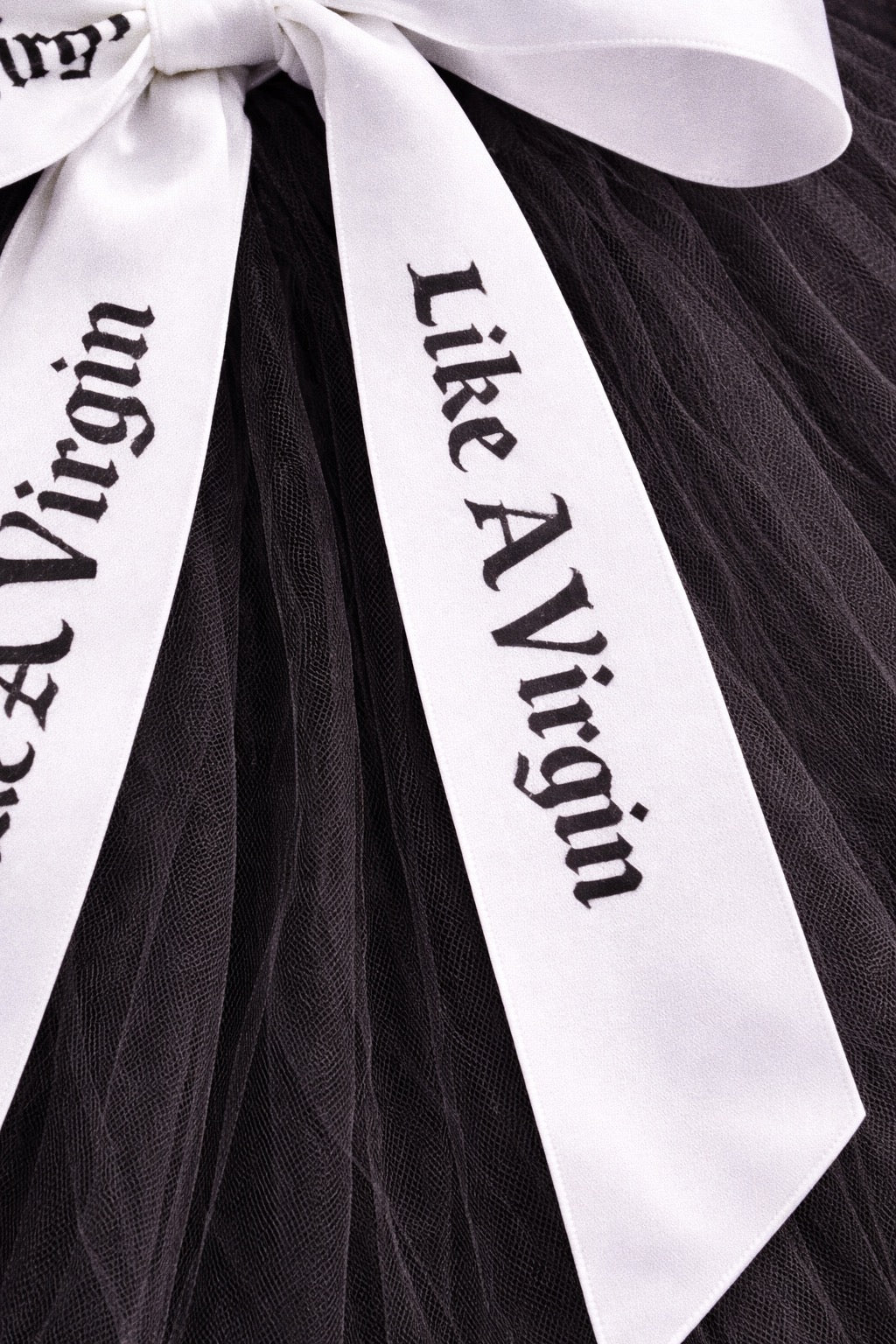 Alternative satin bow wedding veil with white printed ribbons over black tulle for modern bridal styling