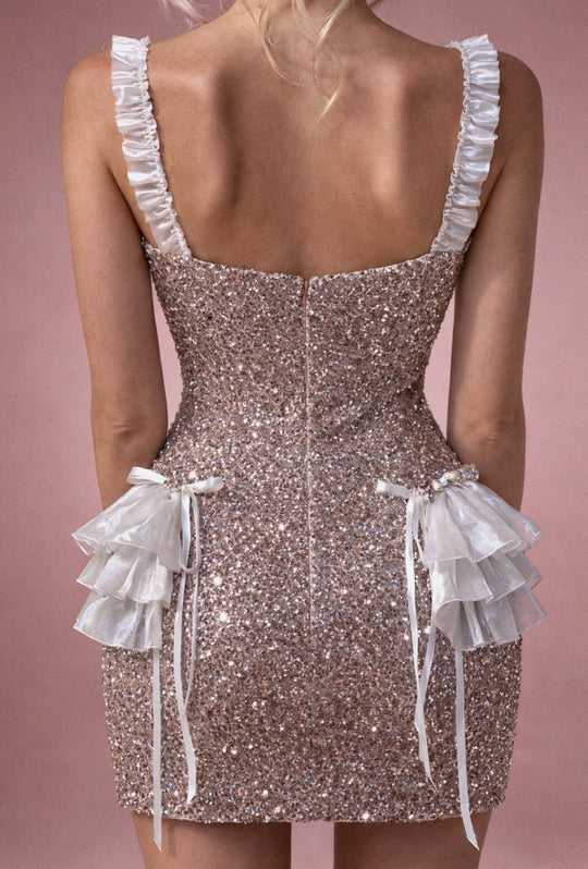 Back view of glitter mini wedding dress with invisible zipper and ruffle hips.