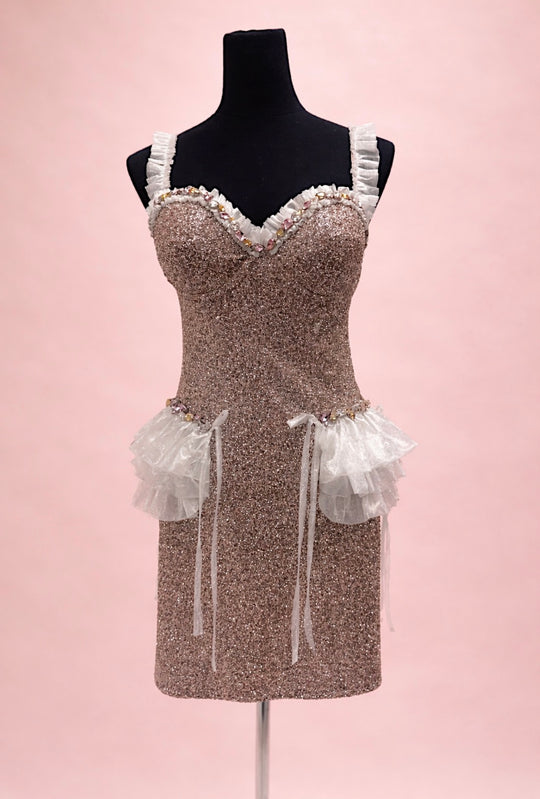 A front view of glitter mini wedding dress with bustier bodice and ruffle hip detail on mannequin.